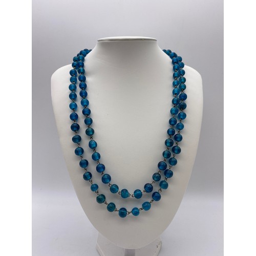 502 - AQUA COLOURED GLASS BALL BEAD NECKLACE, ONE OTHER GLITTER DECORATED STRAND AND AMBER TYPE NECKLACES