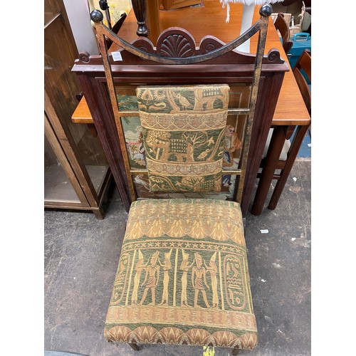 107 - INCA METAL FRAMED CIRCULAR GLASS TOP DINING TABLE AND FOUR EGYPTIAN THEME UPHOLSTERED DINING CHAIRS