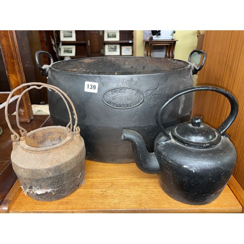 139 - E. PUGH AND CO SIX GALLON BLACKENED TWIN HANDLED CAULDRON AND HEAVY CAST KETTLE