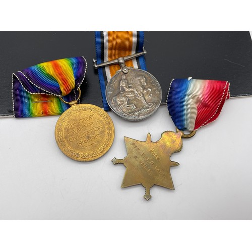 414 - WWI MEDAL TRIO 2864 PTE T.J.G.LANE R.WAR.R AND WITH CAP BADGE