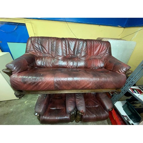 27 - OXBLOOD LEATHER WOODEN SHOW FRAME THREE PIECE SUITE AND FOOTSTOOL