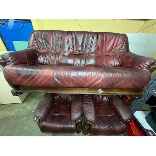 27 - OXBLOOD LEATHER WOODEN SHOW FRAME THREE PIECE SUITE AND FOOTSTOOL