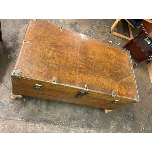 152 - HARDWOOD BRASS MOUNTED TRUNK CONVERTED TO A COFFEE TABLE