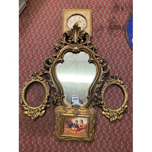 435 - GILT CARTOUCHE FRAMED MIRROR, PAIR OF GILDED CHERUB FRAMES, PAINTED PANEL IN FRAME AND A NEEDLEWORK ... 