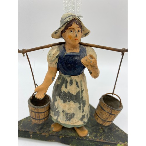 581 - COLD PAINTED METAL DUTCH GIRL WATER CARRIER FIGURAL SPILL VASE