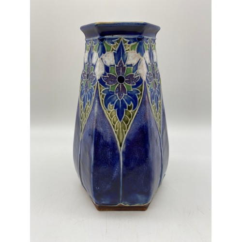 582 - ROYAL DOULTON LAMBETH HEXAGONAL STONEWARE VASE ON A MOTTLED BLUE GROUND BASE IMPRESSED EB 7857