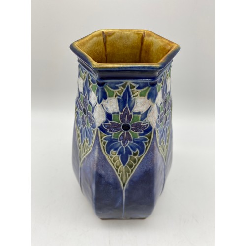 582 - ROYAL DOULTON LAMBETH HEXAGONAL STONEWARE VASE ON A MOTTLED BLUE GROUND BASE IMPRESSED EB 7857