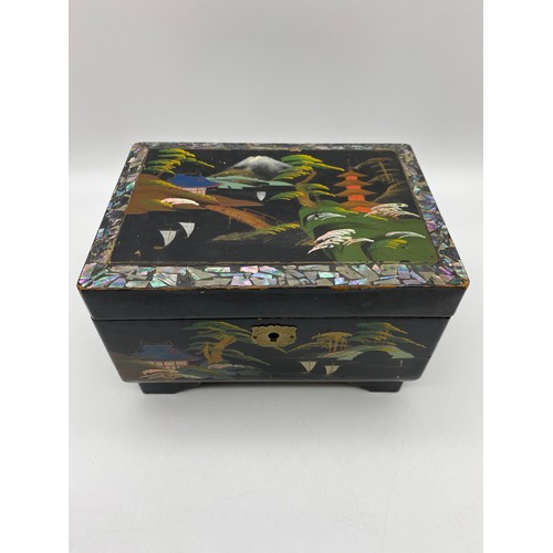 585 - CHINESE LAQUERED CANTILEVER JEWELLERY BOX OF COSTUME BROOCHES, AND A VINTAGE HOME FIRST AID CASE