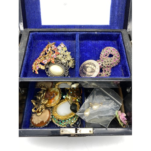 585 - CHINESE LAQUERED CANTILEVER JEWELLERY BOX OF COSTUME BROOCHES, AND A VINTAGE HOME FIRST AID CASE