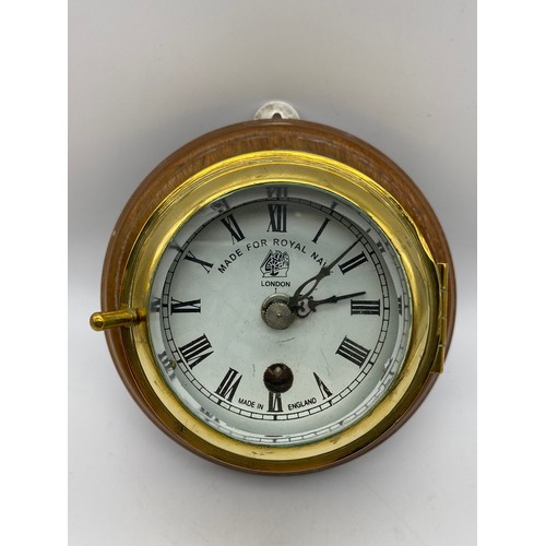 588 - BRASS MARINE PORT HOLE CLOCK MADE FOR THE ROYAL NAVY LONDON IMPRESSED LONDON 1920 ON WOODEN PLAQUE, ... 