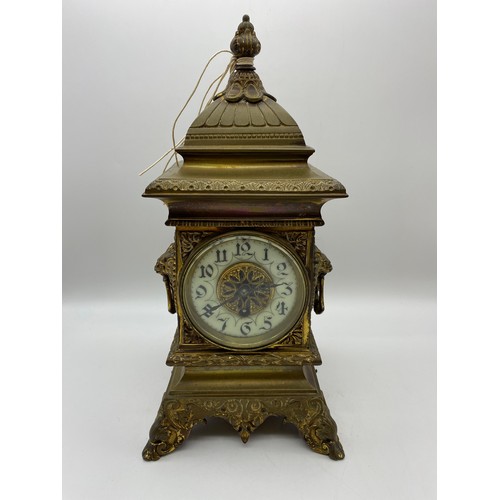 595 - 19TH CENTURY GILT METAL CASED MANTLE CLOCK WITH LIONS MASK HANDLES, DRUM MOVEMENT GLASS A/F