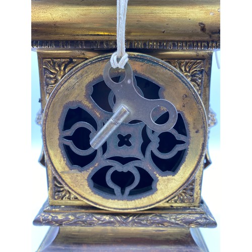 595 - 19TH CENTURY GILT METAL CASED MANTLE CLOCK WITH LIONS MASK HANDLES, DRUM MOVEMENT GLASS A/F