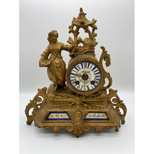 596 - 19TH CENTURY FRENCH GILT SPELTER FIGURAL MANTLE CLOCK WITH BLUE AND WHITE ENAMEL DRUM DIAL AND PORCE... 