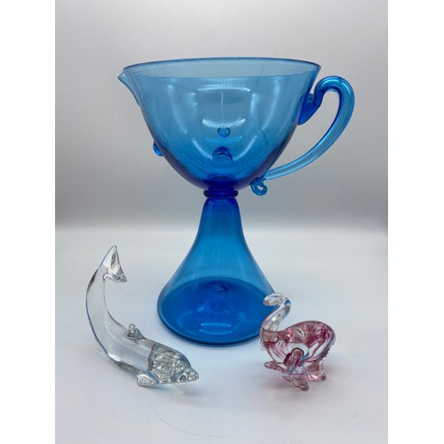 460 - BACARATT CLEAR GLASS DOLPHIN PAPERWEIGHT, HOKITIKA STUDIO GLASS ELEPHANT AND A BLUE GLASS JUG WITH A... 