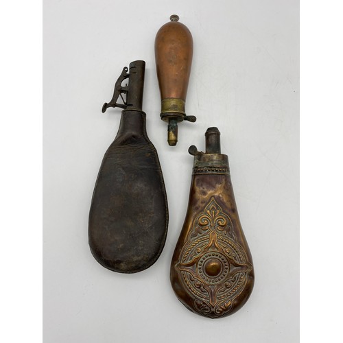 648 - THREE 19TH CENTURY COPPER AND LEATHER COVERED COPPER POWDER SHOT FLASKS