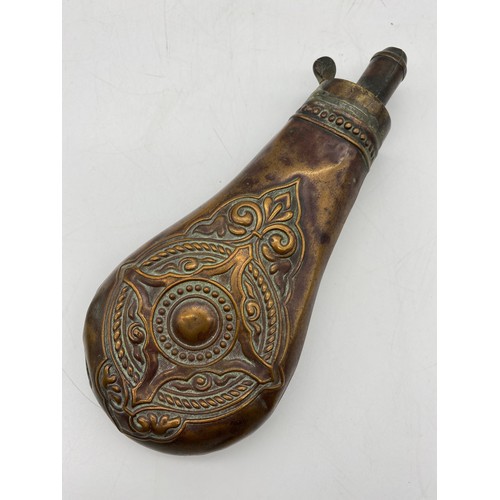 648 - THREE 19TH CENTURY COPPER AND LEATHER COVERED COPPER POWDER SHOT FLASKS