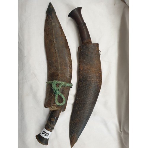 650 - TWO KUKHRI DAGGERS IN LEATHER SHEATHS A/F