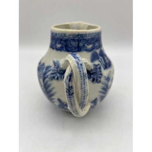 686 - 18TH CENTURY BLUE AND WHITE PAGODA PATTERNED JUG WITH ENTWINED STRAP HANDLE