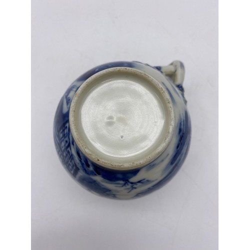 686 - 18TH CENTURY BLUE AND WHITE PAGODA PATTERNED JUG WITH ENTWINED STRAP HANDLE