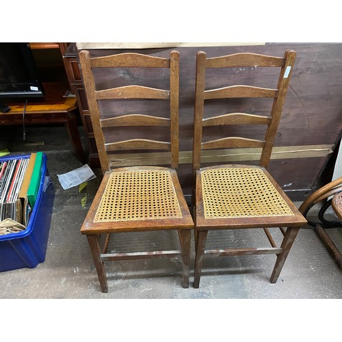 30 - PAIR OF EARLY 20TH CENTURY OAK BREGERE CANED LADDER BACK BEDROOM CHAIRS