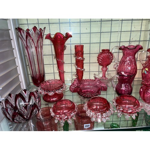 258 - SHELF OF CRANBERRY AND RUBY GLASSWARE INCLUDING CRIMPED EDGE BOWLS, JUGS, AND SILVER OVERLAY SMALL V... 