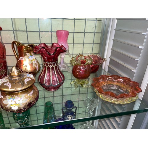 258 - SHELF OF CRANBERRY AND RUBY GLASSWARE INCLUDING CRIMPED EDGE BOWLS, JUGS, AND SILVER OVERLAY SMALL V... 