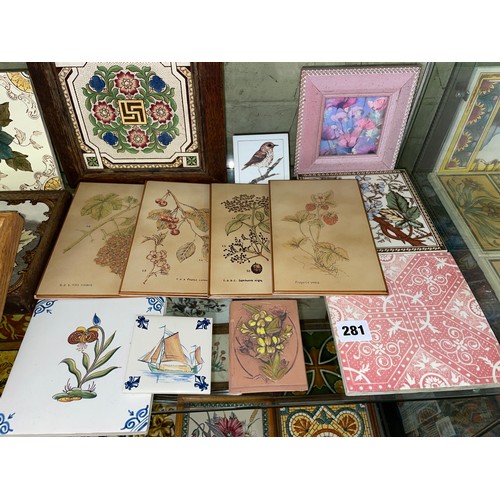 281 - TWO SHELVES OF DECORATIVE CERAMIC TILES AND TILE TRIVETS DECORATED WITH MAINLY FLOWERS AND ANIMALS