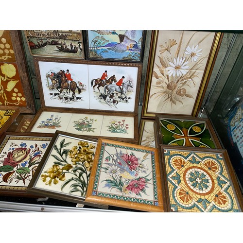 281 - TWO SHELVES OF DECORATIVE CERAMIC TILES AND TILE TRIVETS DECORATED WITH MAINLY FLOWERS AND ANIMALS