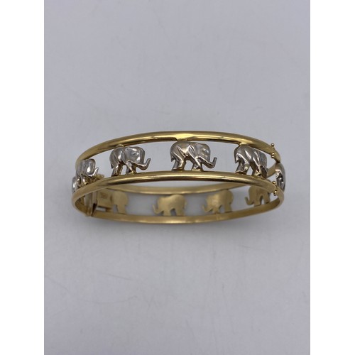 511 - UNMARKED YELLOW AND WHITE METAL ELEPHANT BANGLE