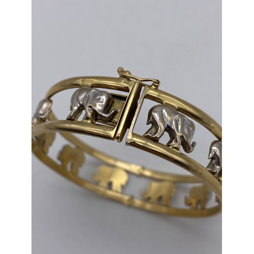 511 - UNMARKED YELLOW AND WHITE METAL ELEPHANT BANGLE