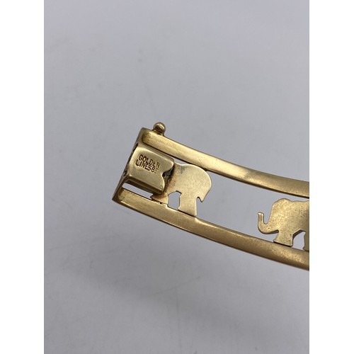 511 - UNMARKED YELLOW AND WHITE METAL ELEPHANT BANGLE