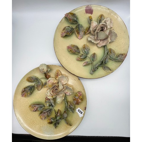 528 - PAIR OF FLORAL ENCRUSTED POTTERY WALL PLAQUES