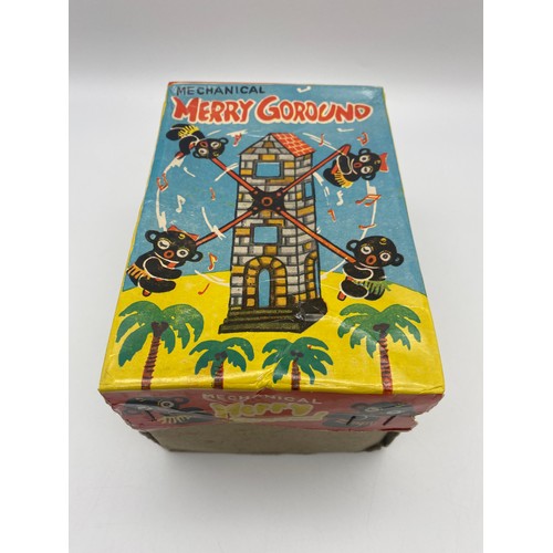 262 - BOXED MECHANICAL MERRY GOROUND TIN PLATE TOY