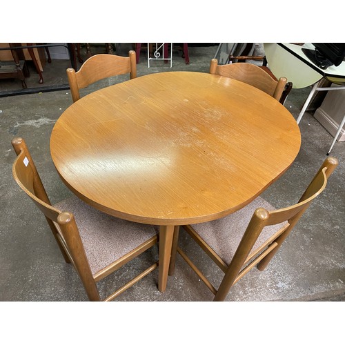 49 - OVAL TEAK DINING TABLE AND FOUR BAR BACK CHAIRS