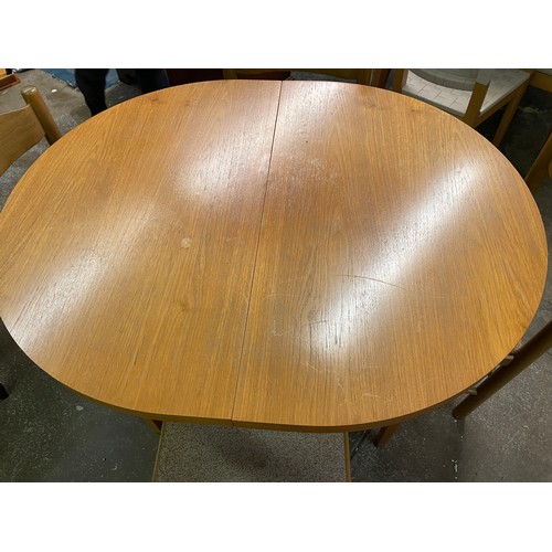 49 - OVAL TEAK DINING TABLE AND FOUR BAR BACK CHAIRS