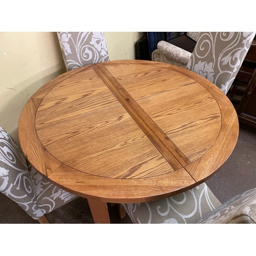 139 - CIRCULAR OAK DINING TABLE AND FOUR FABRIC UPHOLSTERED CHAIRS