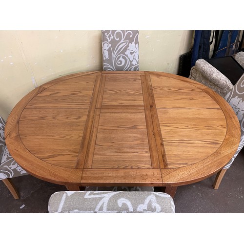 139 - CIRCULAR OAK DINING TABLE AND FOUR FABRIC UPHOLSTERED CHAIRS