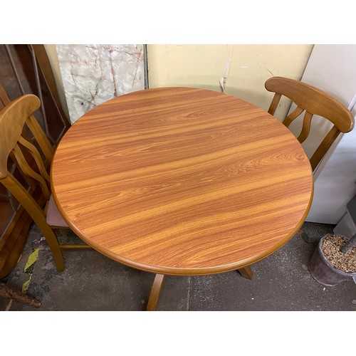 137 - TEAK CIRCULAR PEDESTAL BREAKFAST TABLE AND PAIR OF DINING CHAIRS