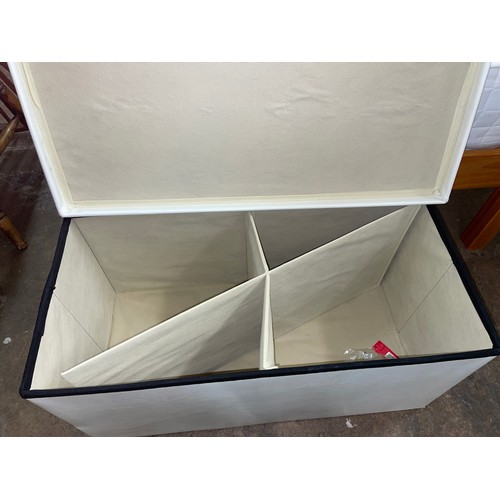 184 - CREAM STITCHED STORAGE OTTOMAN