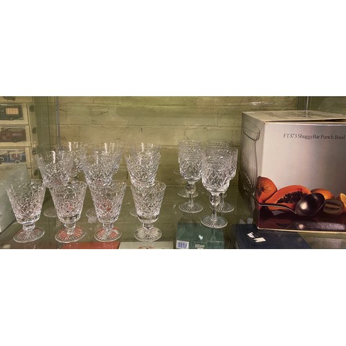 232 - TWO SHELVES OF DIAMOND CUT DRINKING GLASSES, COMMEMORATIVE DECANTER, PUNCH BOWL, AND OTHER GLASSWARE