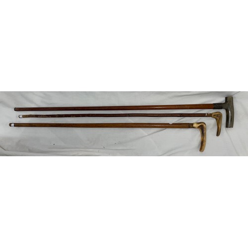 549 - THREE HORN HANDLED WALKING STICKS