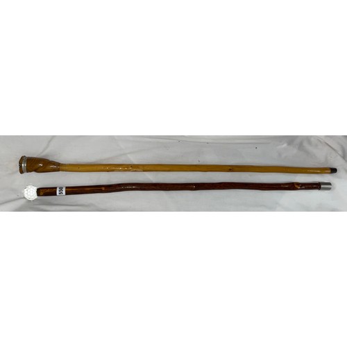 550 - TWO WALKING STAFFS WITH GLASS POMMELS