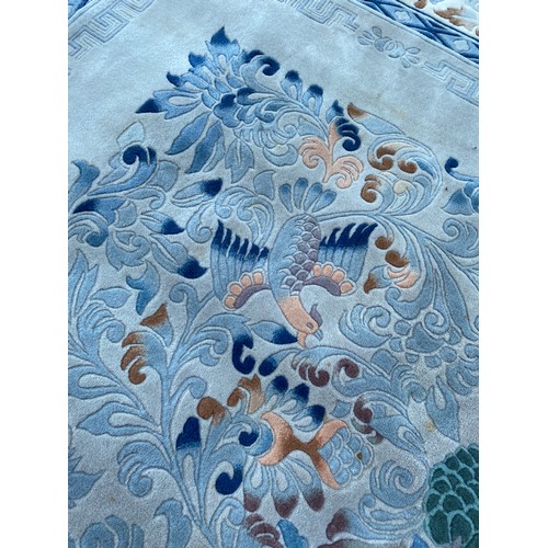 14 - CHINESE WOOL PILE FRINGED CARPET DECORATED WITH FOLIAGE AND BIRDS ON A BLUE GROUND SIZE 2.44 X 2.44 ... 