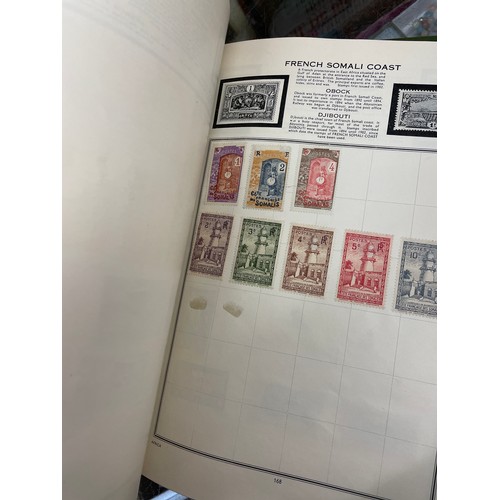 501 - DIPLOMAT AND THE IDEAL STAMP ALBUMS OF WORLD STAMPS, VINTAGE TINS OF FRANKED WORLD STAMPS