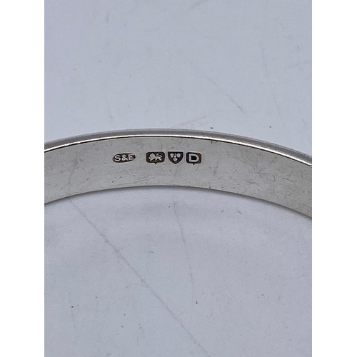 394 - STERLING SILVER ENGRAVED SCALLOPED BROOCH, SILVER ENGRAVED BANGLE WITH SAFETY CHAIN