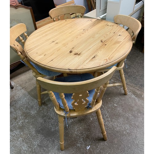 16 - PINE CIRCULAR EXTENDING TABLE WITH FOUR COUNTRY CHAIRS