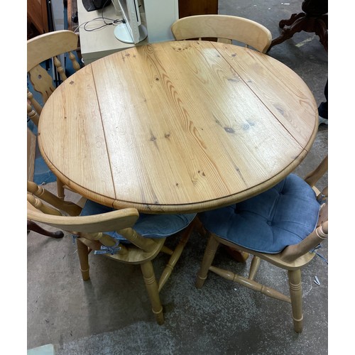 16 - PINE CIRCULAR EXTENDING TABLE WITH FOUR COUNTRY CHAIRS