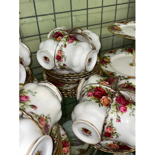 211 - SHELF OF ROYAL ALBERT OLD COUNTRY ROSES DINNER AND TEA SERVICE INC. PLATES, CAKE STAND AND TEAPOT