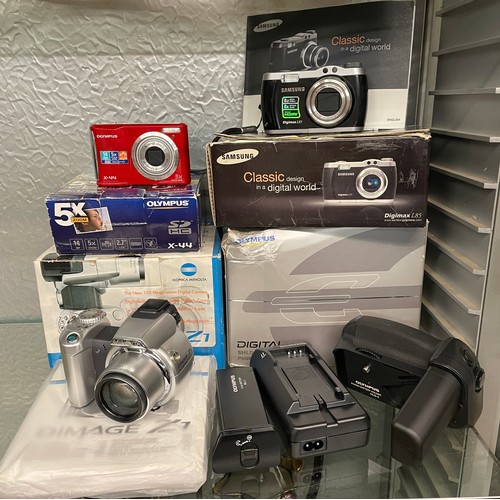 215 - BOXED OLYMPUS X-44 CAMERA, OLYMPUS SHLD-2 POWER BATTERY HOLDER SET, SAMSUNG DIGIMAX L85 AND A KONICA... 