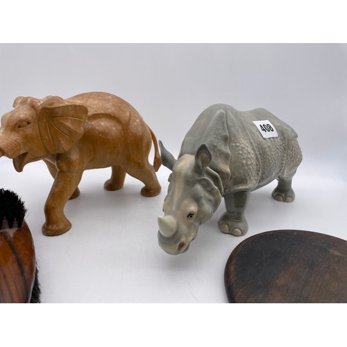 408 - CARVED WOODEN ELEPHANT, POTTERY RHINOCEROS, WOODEN BACKED HAND MIRROR AND A BRUSH